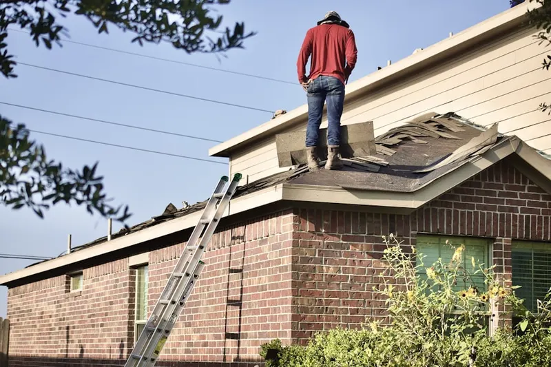Professional roofer working on a residential roof in Corpus Christi